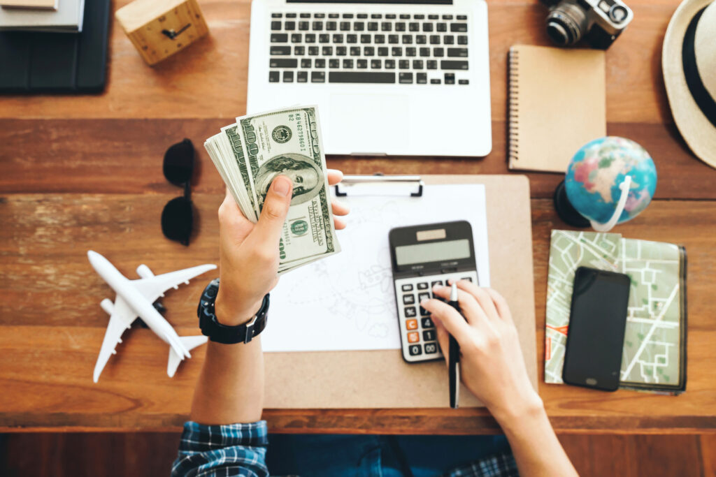 10% rule. Top view tourist counting cash to spend during his luxury vacation, planning budget