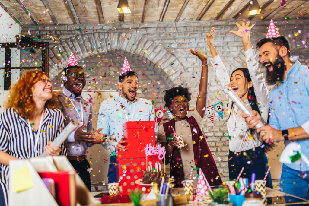 affordable birthday party. Businesspeople celebrating their colleagues birthday in office.