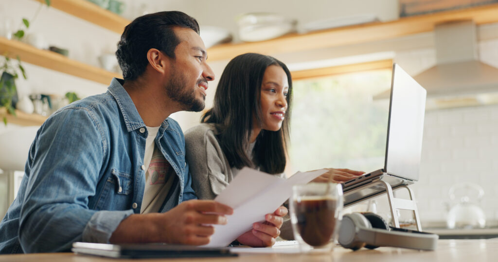 Reverse budgeting. Home, talking and couple with a laptop, paperwork and communication with investment, financial planning and internet connection. Documents, man and woman with technology, speaking and website info