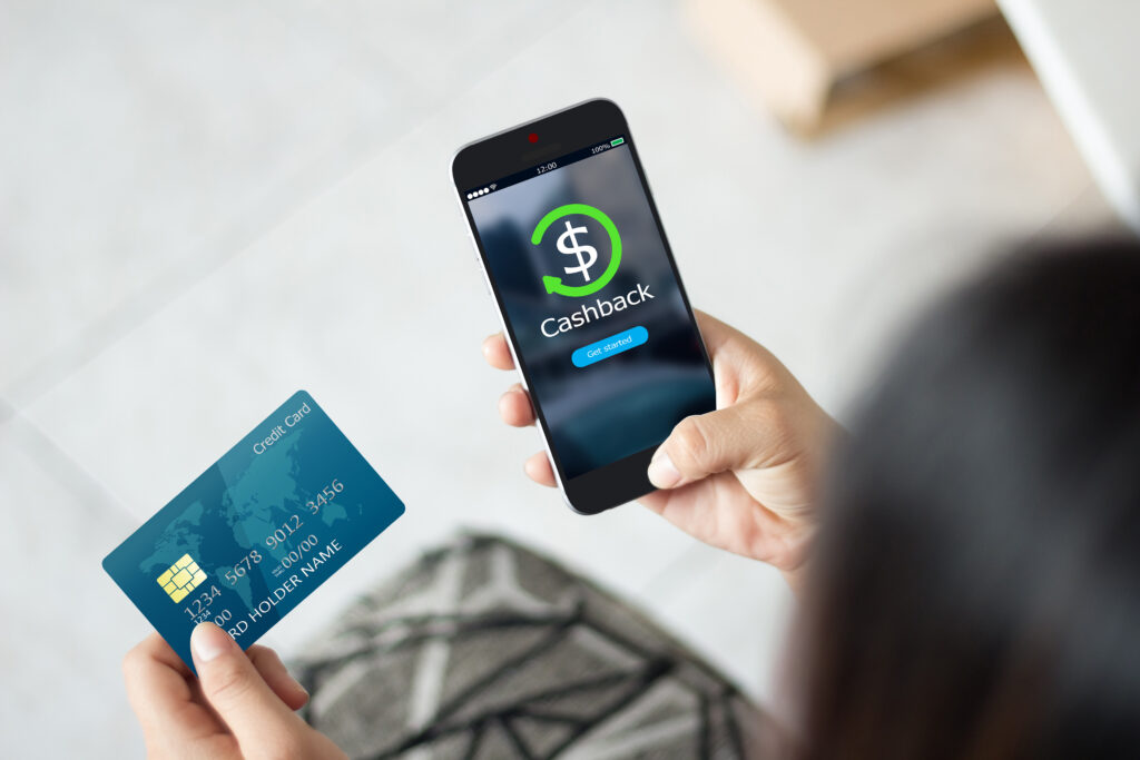 rewards points. Female hands using mobile phone and holding credit card